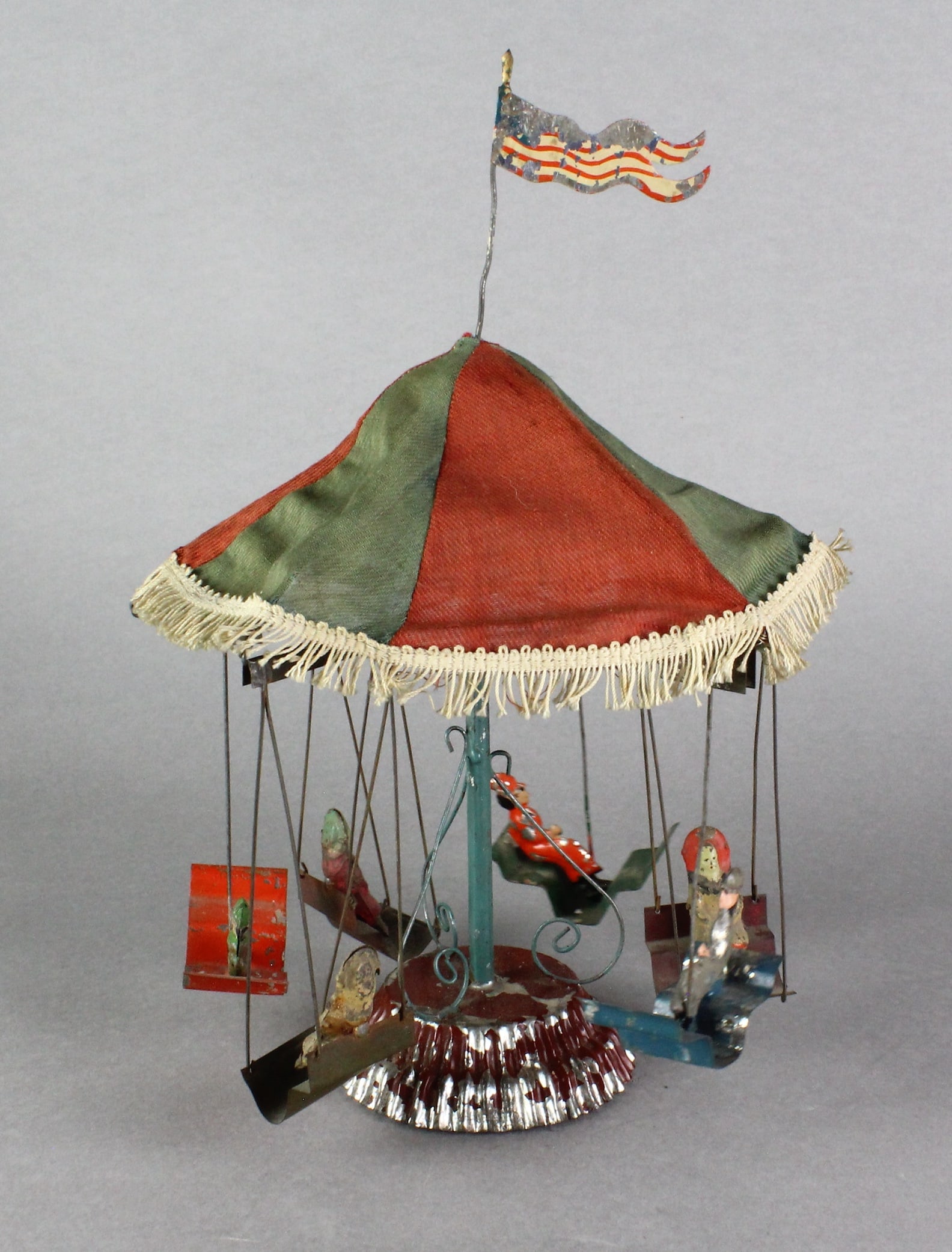 German Tin Carousel with Cloth Top: 1900s German Tin Carousel with Cloth Top. 6 riders, 12 1/2 inches tall.