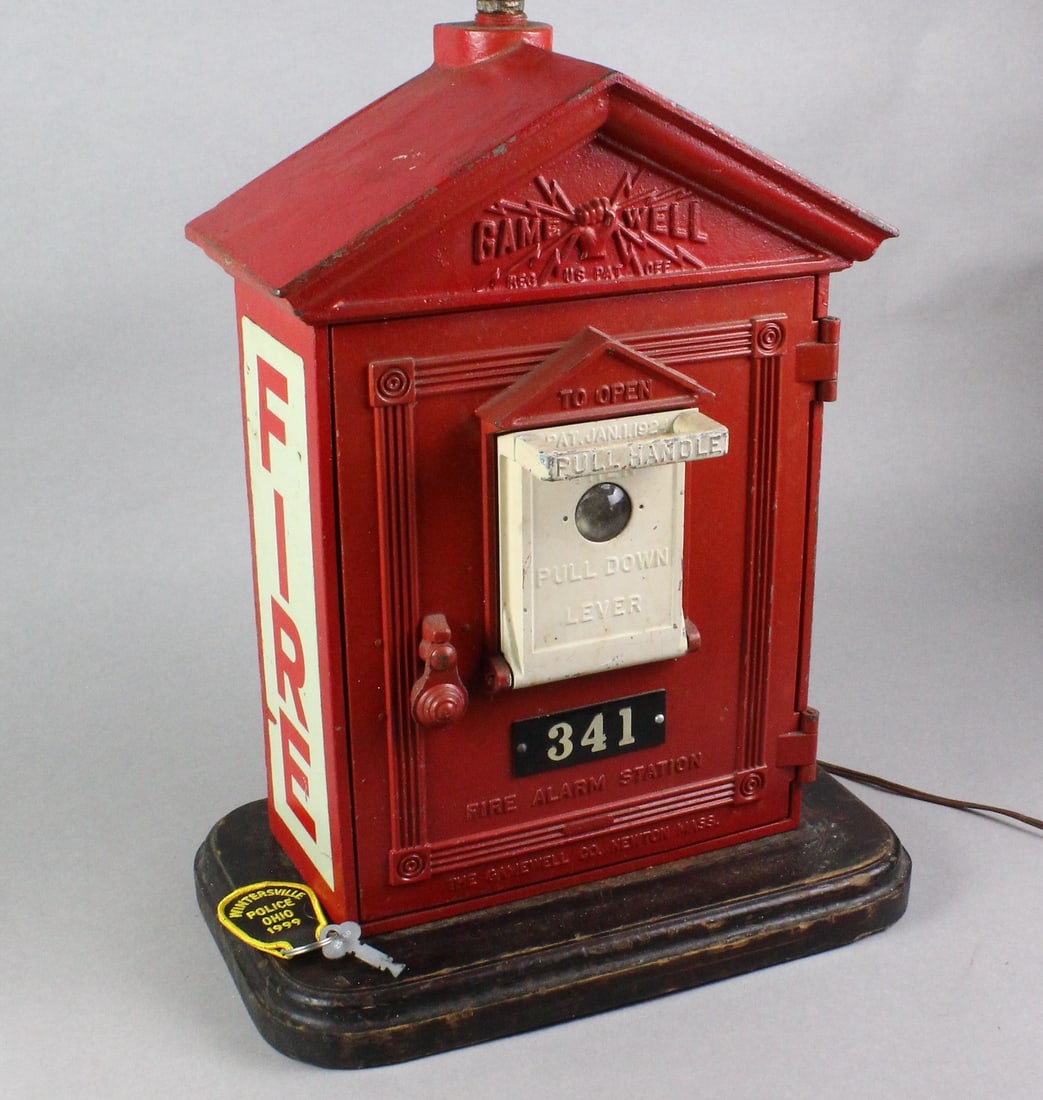 Gamewell Iron Fire Alarm Station: Gamewell Iron Fire Alarm Station with key. Stand alone or can be used as current set up as a statement fire alarm lamp with fire helmet shade. Either way ready to go. Cast iron with aluminum inside.