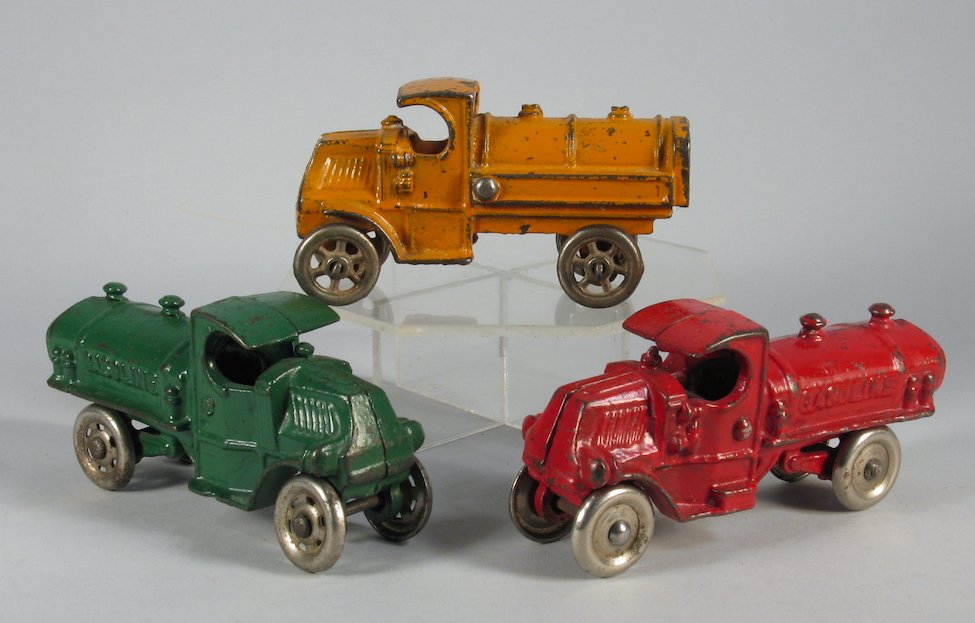 3 Hubley and Champion Mack Tanker Trucks: 3 Cast Iron Tank Mack Trucks in colorful original paint. Measure 4 inches long.