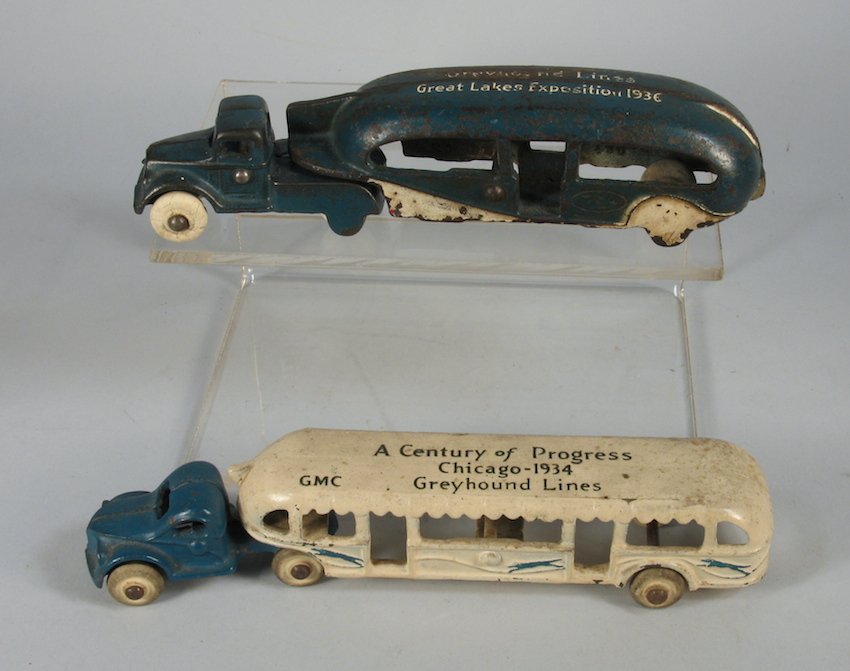 Pair of Arcade Cast Iron Greyhound Buses: Pair of Arcade World's Fair buses. One bus is the unusual 1936 Great Lakes Exposition bus and the other is the Chicago 1934 Century of Progress bus. Measure 6 1/2 to 7 1/2 inches long.
