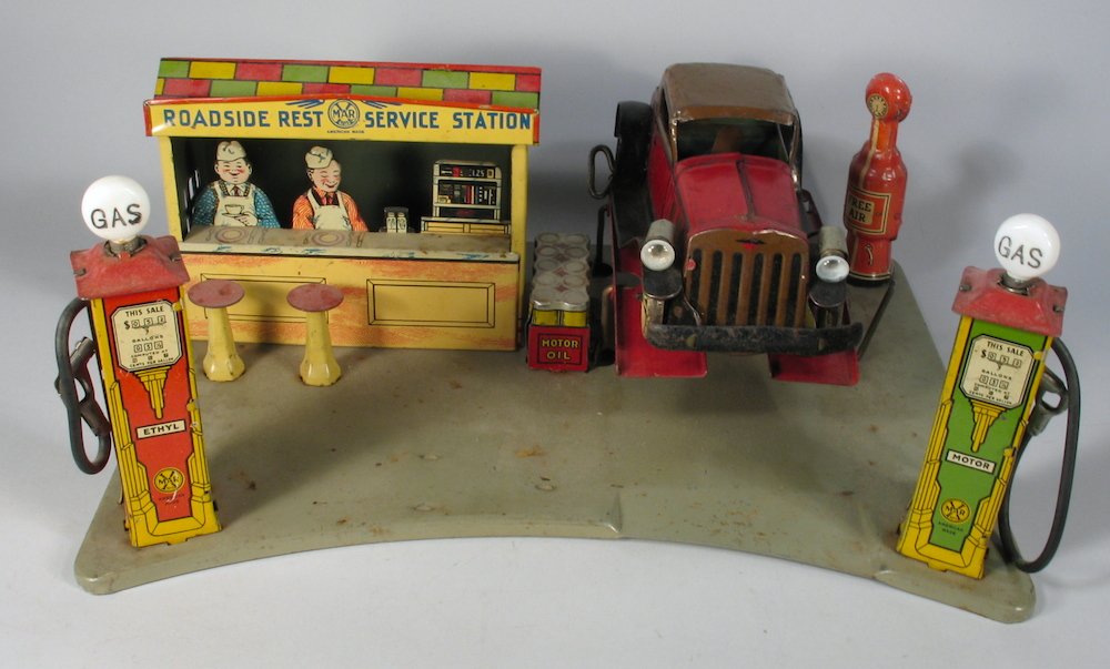 Louis Marx Roadside Rest with Gas Pumps & Light up: Marx Tin Roadside Rest Service Station with 1930s Marx wind up Marx Coupe with lights. Station is 14 inches wide, car is 7 12 inches long.