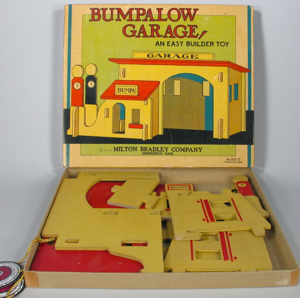 1920s Bumpalow Garage in the Box Milton Bradley: Ex Kauffman Collection California style bungalow gas service station unbuilt in the original box. Box is 11 1/2 inches wide.
