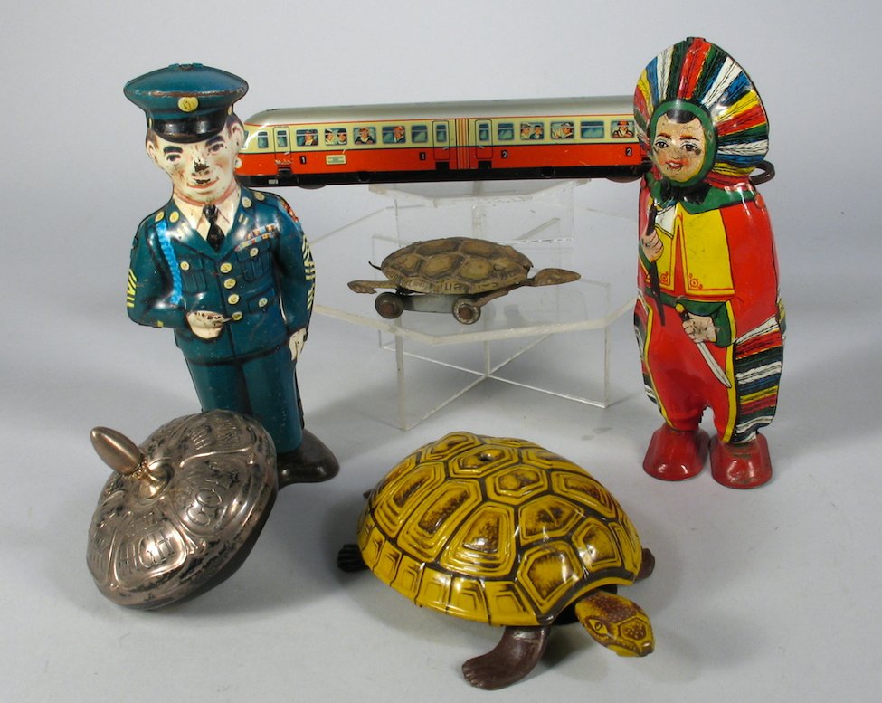 Chein Tin and German Tin Toy Wind Up Lot: J. Chein Tin Sergeant and Indian Wind Up Walking Toy 5 1/2 inches tall. 2 German tin Turtles, larger marked Lehmann. Lehmann Tin Tram car 8 inches long. Nickel spinning top with sayings to a game. Nic