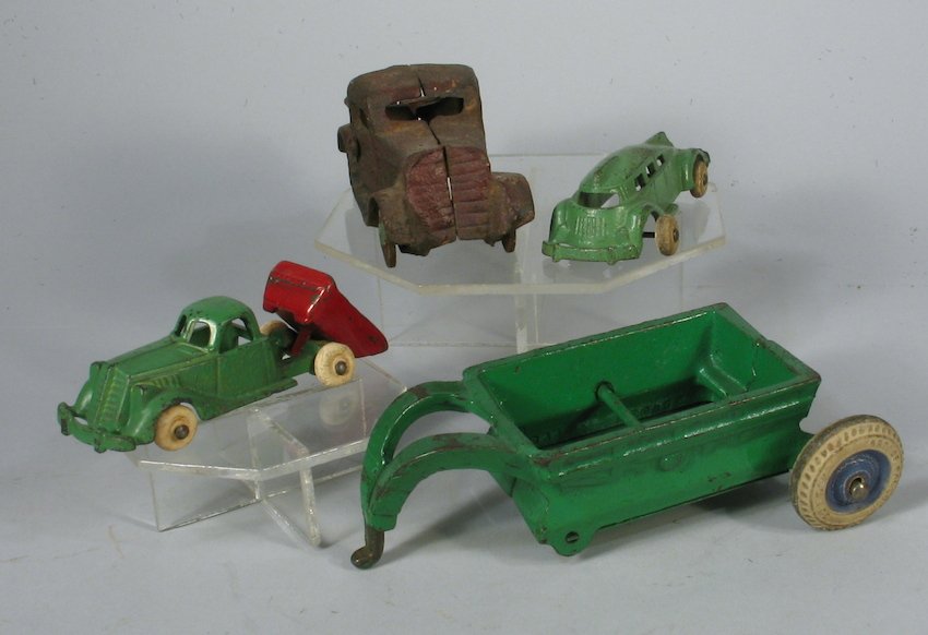 Arcade and Hubley Cast Iron Lot Arcade Plymouth: Hubley small Dump truck, Arcade spreader, Hubley Futuristic car, Arcade Plymouth. Measure 3 1/2 to 5 inches long. Fair shape on the Plymouth, others excellent.