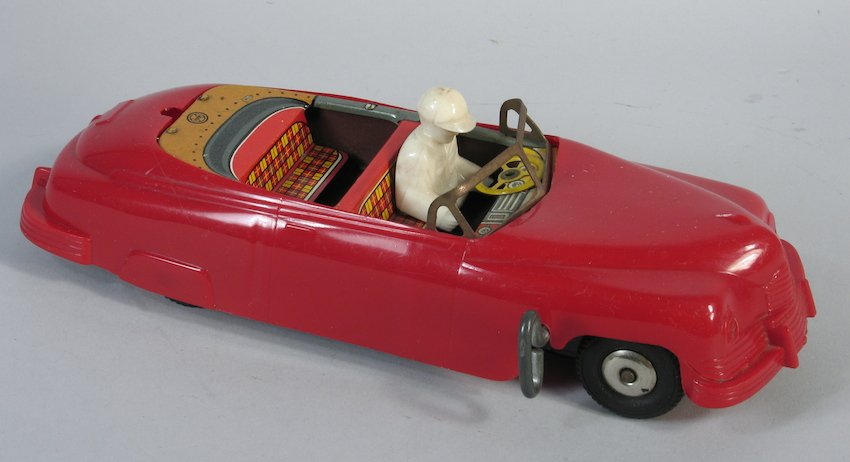 Marx 2 Cars In One Racer or Passenger Flip Car: Marx tin top flips over as a race car driver or a family out for a drive in this unusual wind up car. Measures 7 inches long.