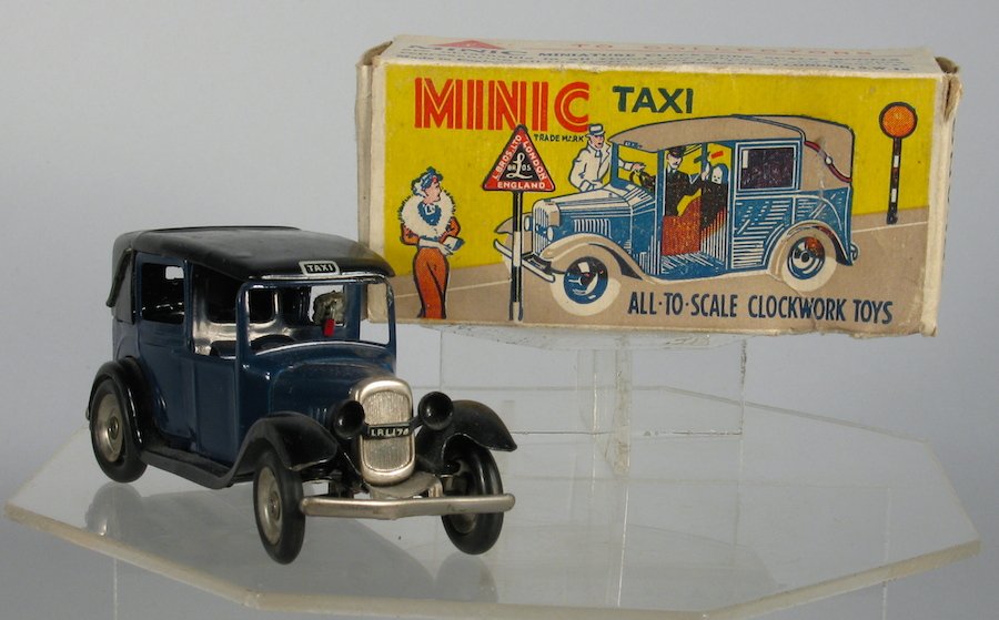 Minic Tri-Ang Taxi in the Original Box: Pre War Minic Taxi Cab in Original Box. Excellent working wind up made in England. Measures 4 1/4 inches long.