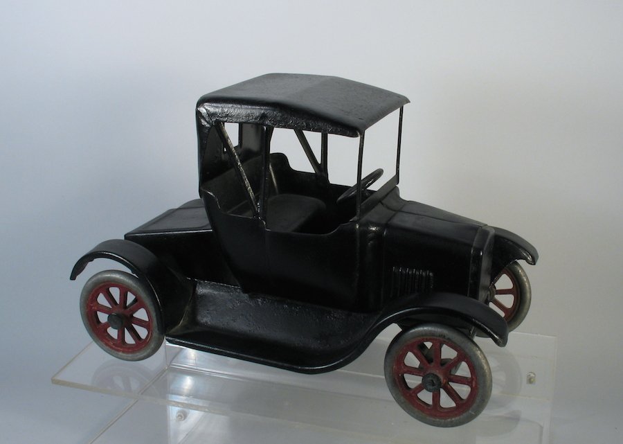 Buddy L Flivver Ford Coupe: 1920s Buddy L Ford Flivver Pressed Steel car. Simulated soft top (folding) model. Measures 11 inches long. Very old repaint.