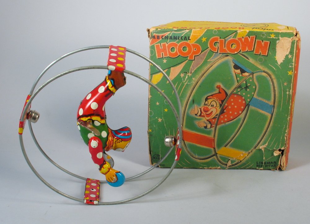 Linemar Tin Hoop Clown In the Box: Linemar Marx Japan tin clown in hoop toy wind up. Pristine toy in rare but rough box. Measures 6 inches wide.