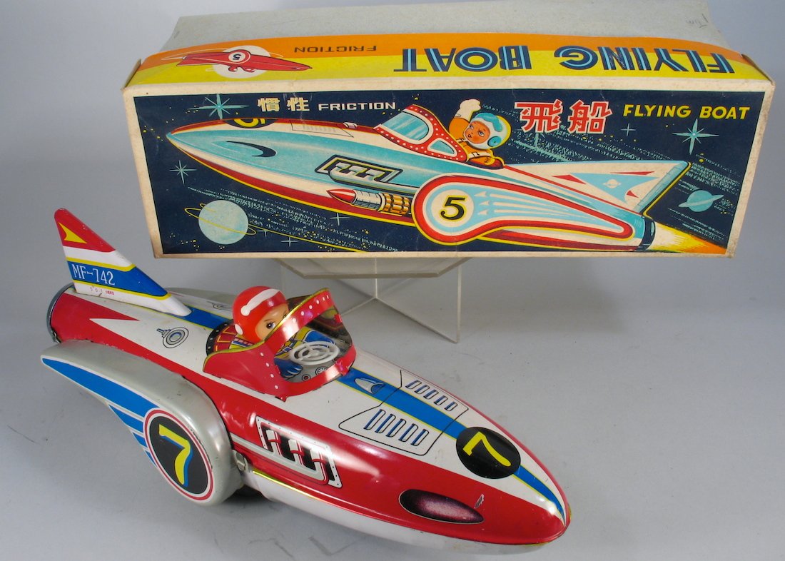 Red China Space Boat in Box: Tin toy Rocketship Space Boat with Astronaut. Great graphic box. Measures 12 inches long.