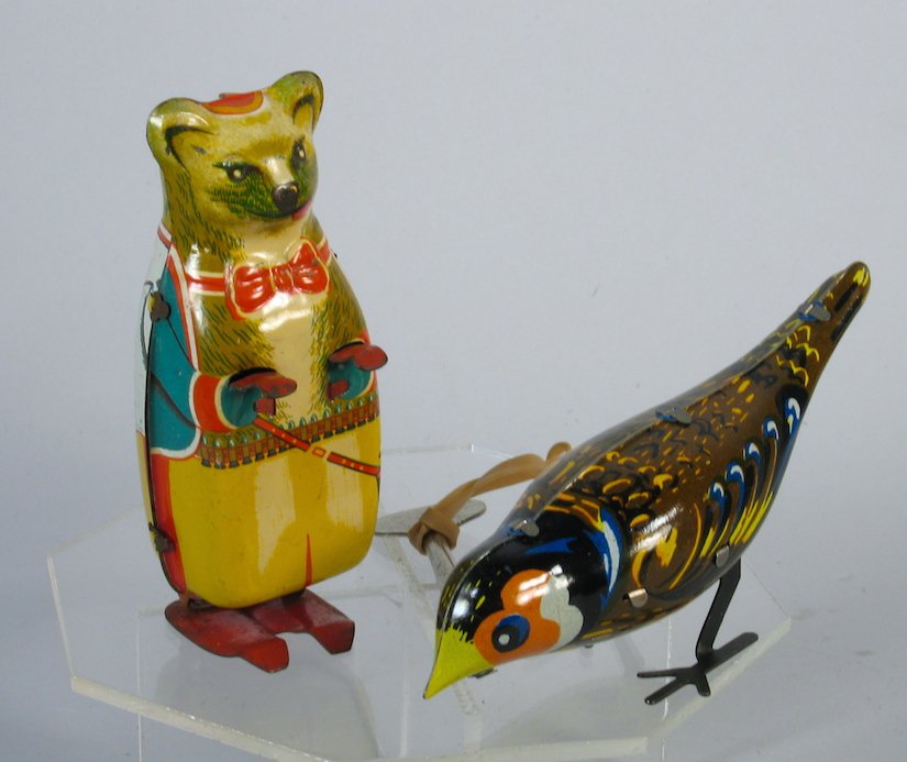 German Hofler Bear and Pecking Bird: German Hofler Bear with six gun and Pecking Bird wind up toys. Tallest measures 4 inches tall.