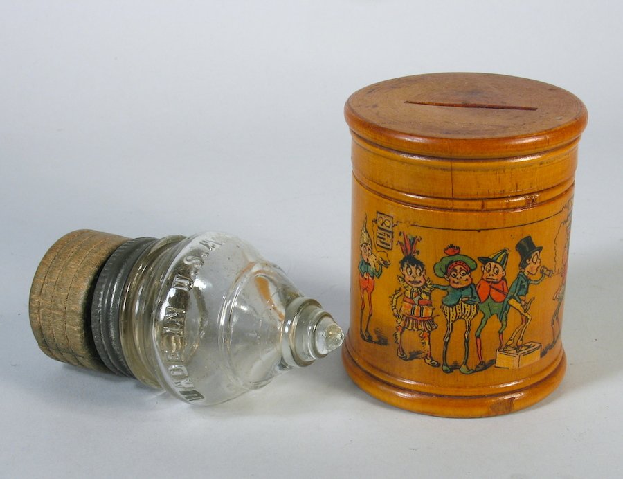 1900s Palmer Cox Brownie Bank & Glass Spinning Top: 1900s Palmer Cox Brownies Bank & Glass spinning Top with metal take off mechanism. Unusual early wooden bank with the famous characters and spinning glass top. Bank is 3 1/2 inches tall.