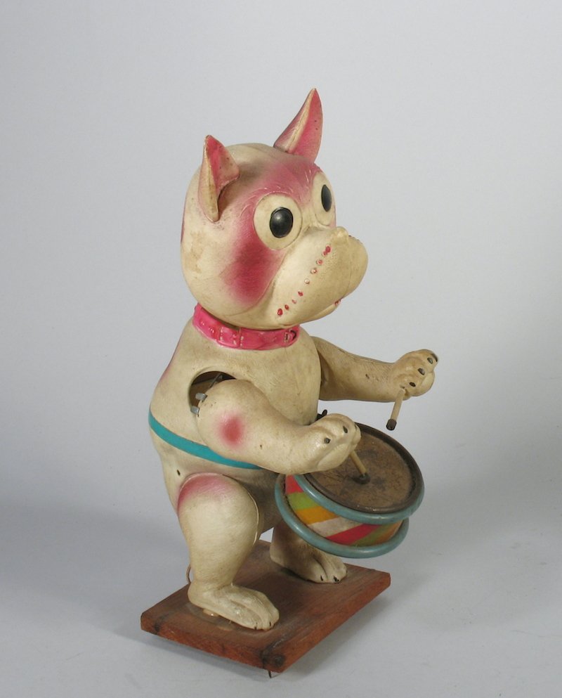 Japan Celluloid Bonzo the Dog Drummer: Pre-War Japan celluloid Bonzo drumming dog wind up. Very rare celluloid toy. Spring is weak, wind up not working. Large celluloid toy is 9 inches tall.
