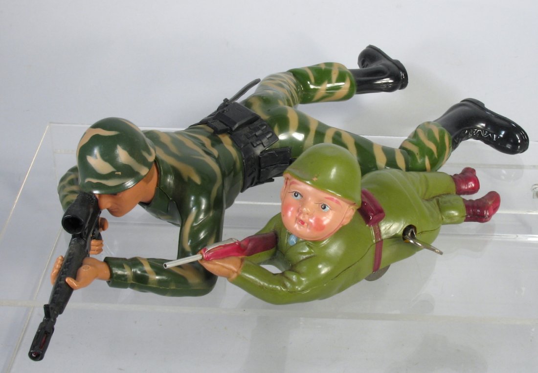 Japan Celluloid Toy Crawling Soldier & Battery Op: Occupied Japan Celluloid Toy Crawling Soldier wind up and crawling soldier battery op. Uncommon WWII era celluloid soldier turns his head as he simulates crawling with his rifle. Both in excellent wor