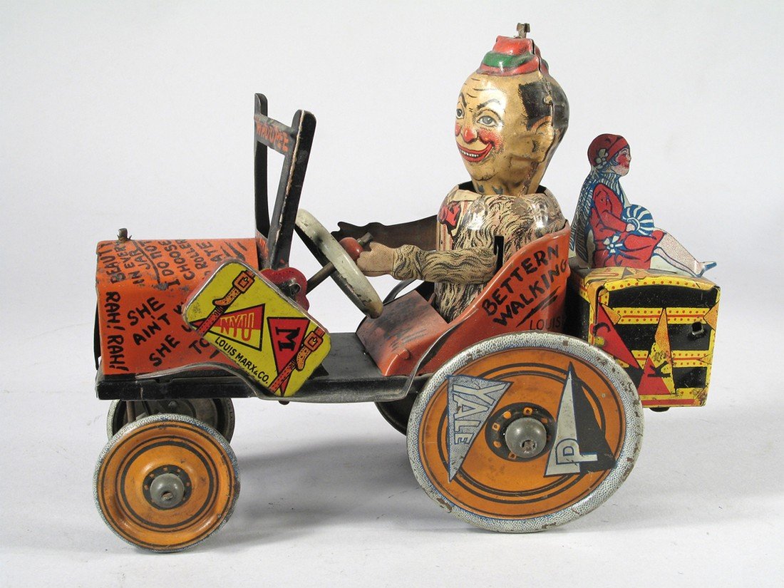1920s Louis Marx Tin Whoopee College Crazy Car Flivver: 1920s Louis Marx Tin Whoopee College Crazy Car Flivver with flapper girls. Frat boy complete in a Rah-Rah raccoon coat drives the car with all the University pennants- Yale, Princeton, Vassar, U of VA