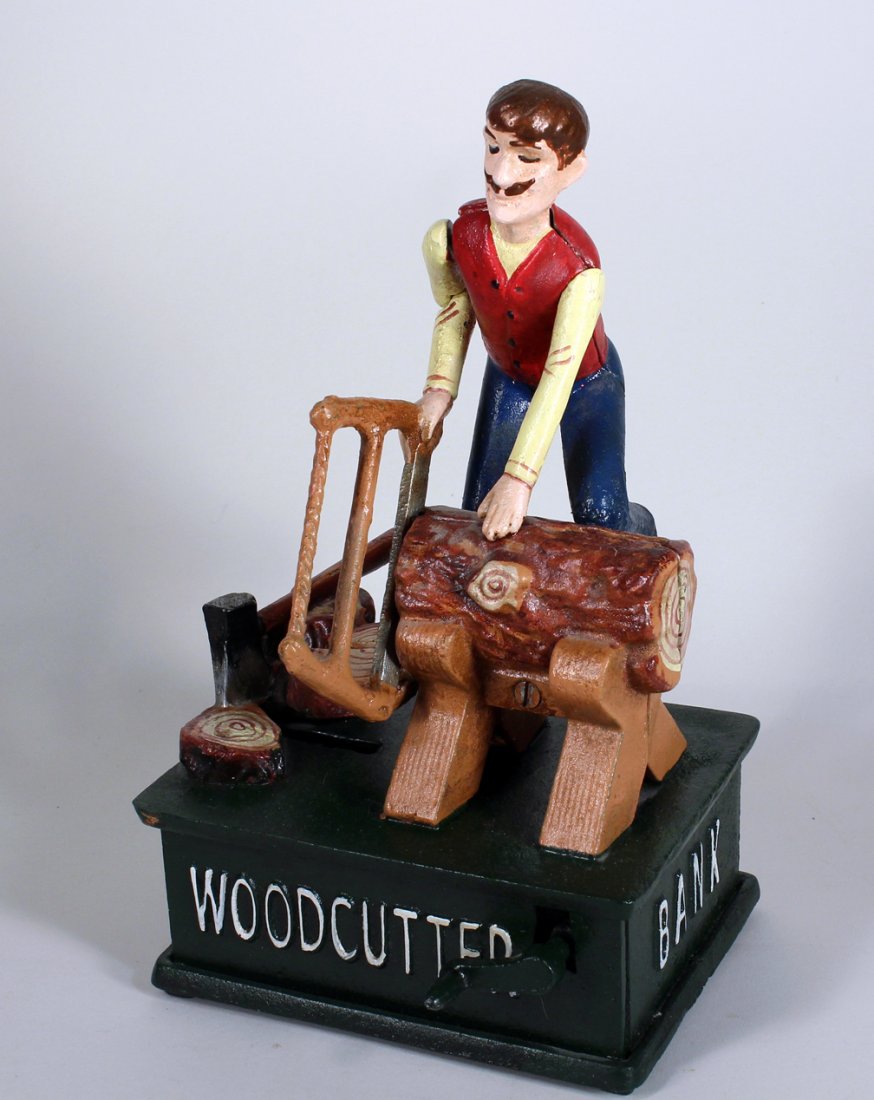 Cast Iron Wood Chopper Mechanical Bank: Cast Iron Wood Chopper Mechanical Bank.Cast iron wood cutter bank.reproduction, 9 1/2 inches tall.