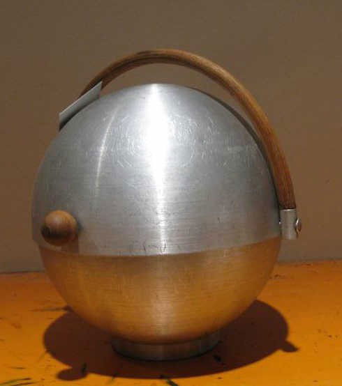 RUSSEL WRIGHT, AMERICAN: Spun aluminum bun holder, globular form with bentwood handle and finial, complete with interior wirework net. 9 inches