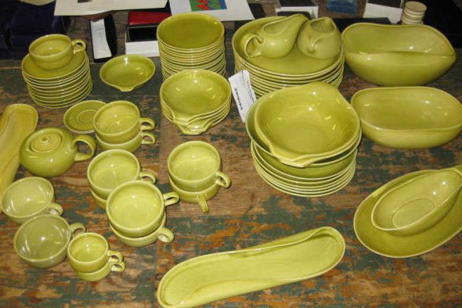 RUSSEL WRIGHT POTTERY DINNER SERVICE: Green pottery bowls, plates, cups and serving bowls.