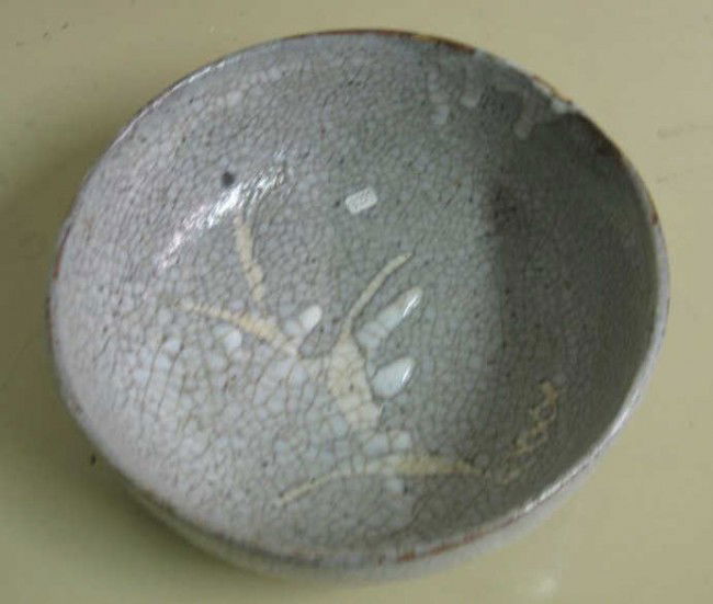 JAPANESE CRACKLE GLAZE EARTHENWARE BOWL: white character on celadon glazed ground, marked underfoot. 3 x 8 3/4 inches
