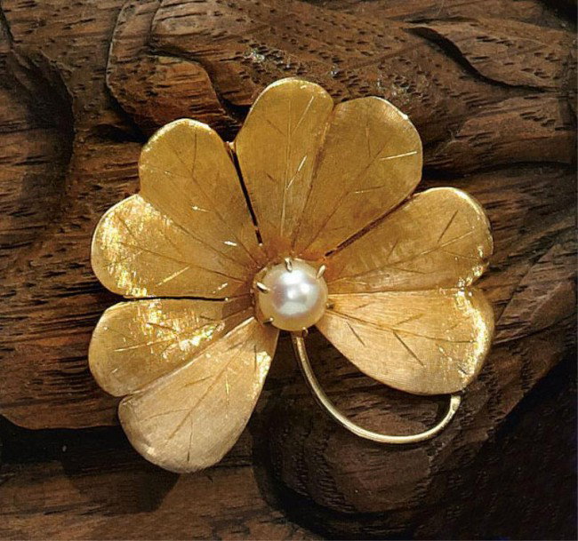 PEARL BROOCH: 14k yellow gold hand engraved four leaf clover set with one cultured pearl. 1 1/4 inches. 5.2 grams