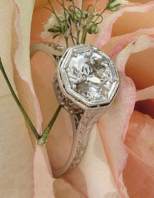 DIAMOND RING: Platinum solitaire ring with filigree undercarriage set with one European cut diamond weighing 1.05ct.
