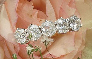 DIAMOND WEDDING RING: 14k yellow gold single row wedding ring set with five mine cut diamonds weighing 2.00ct.t.w.