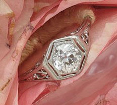 DIAMOND RING: Platinum filigree solitaire ring set with one European cut diamond weighing approximately .80ct. Size 7