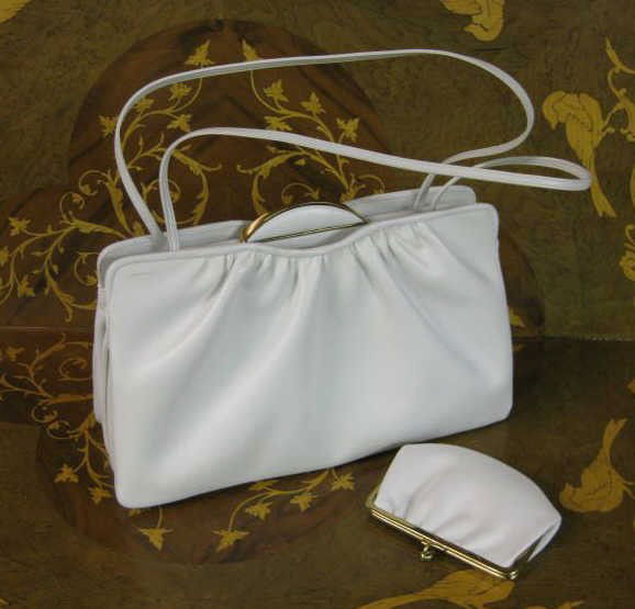 JUDITH LEIBER: White leather handbag with coin purse, like new condition.