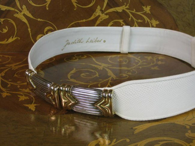 JUDITH LEIBER: White leather belt with silver and gold tone clasp.