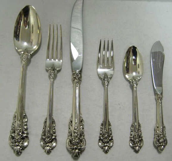 WALLACE SILVERSMITHS, WALLINGFORD, CT: Sterling silver "Grande Baroque" flatware service (1941) comprising 12 dinner knives (9 7/8"), 11 dinner forks, 12 salad forks, 10 luncheon forks, 12 teaspoons, 2 table spoons, sugar spoon, olive fork