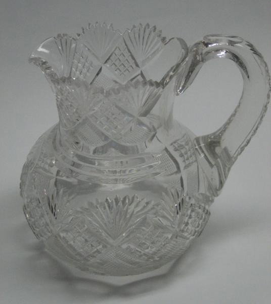 BRILLIANT CUT GLASS PITCHER: Diamond, strawberry diamond, rosette and fan motifs, early 20th century. Height 8 in.