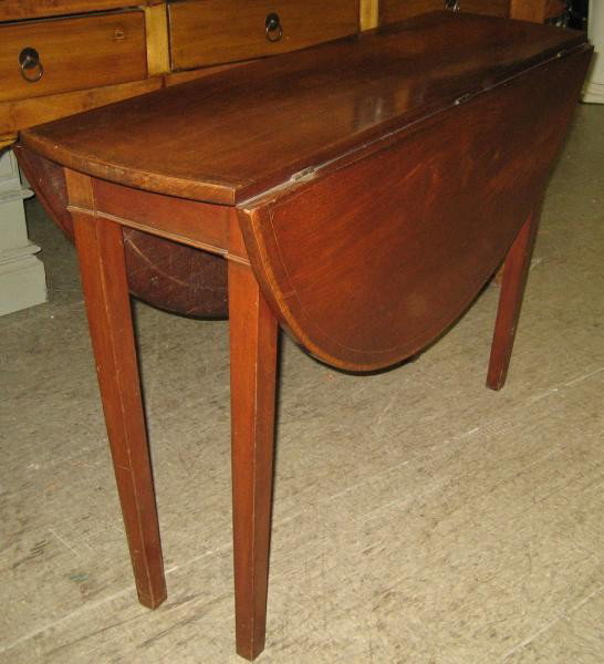 ANTIQUE ENGLISH INLAID MAHOGANY DROP LEAF TABLE: Circular crossbanded top, with twin drop leaves, on tapering square legs. Height 29 1/2. diameter 43 in.
