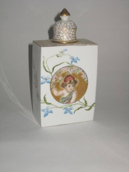 FRENCH PORCELAIN LIDDED JUG OR TEA CADDY: Rectangular with short neck, hand painted reserve of Classical child and floral sprays, 20th century. Height 6 5/8 in.