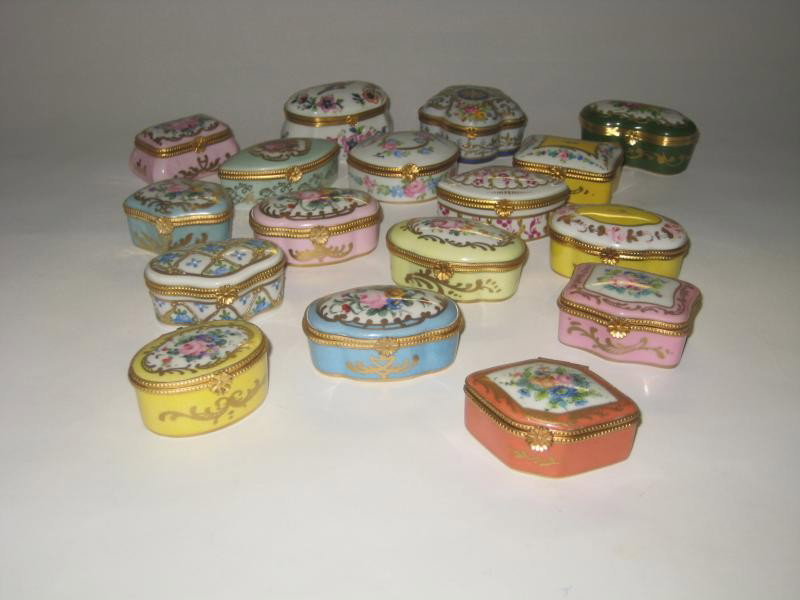 FRENCH LIMOGES PORCELAIN BOXES: Seventeen small boxes of various shapes and hand painted decoration, mostly floral, one with exotic bird and one with romantic couple, each ormolu mounted, bearing many decorating marks including Le T