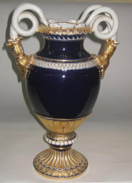 MEISSEN PORCELAIN EMPIRE-STYLE URN: Molded after Leuteritz, cobalt blue grounded vasi-form with two double-coiled snake handles emerging from acanthus terminals, gilt highlights, imperfections, 'pommel crossed swords' mark, 19th/20th ce
