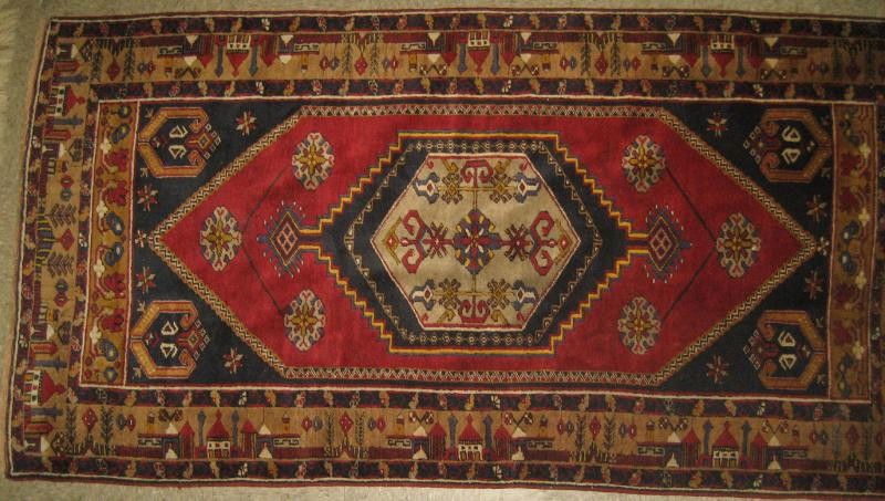 TURKISH AREA RUG: Off white on navy geometric medallion, on the red field with navy spandrels, ochre border with guard borders. 3 ft. 9 in. x 7 ft. 2 in.
