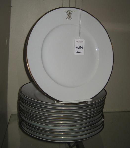 SET OF TWELVE SWEDISH PORCELAIN PLATES: decorated with gilt rim, monogrammed, marked Upsala Ekeby, Karlskrona. Diameter: 9 1/2 inches