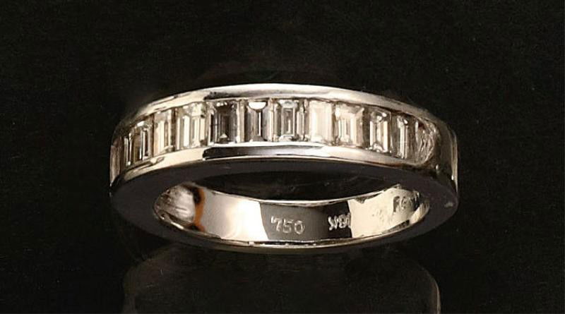 BAGUETTE CUT DIAMOND WEDDING RING: 18k white gold ring with twelve baguette cut channel set diamonds weighing .80ct.t.w. 6.1 grams. Size 6 3/4.
