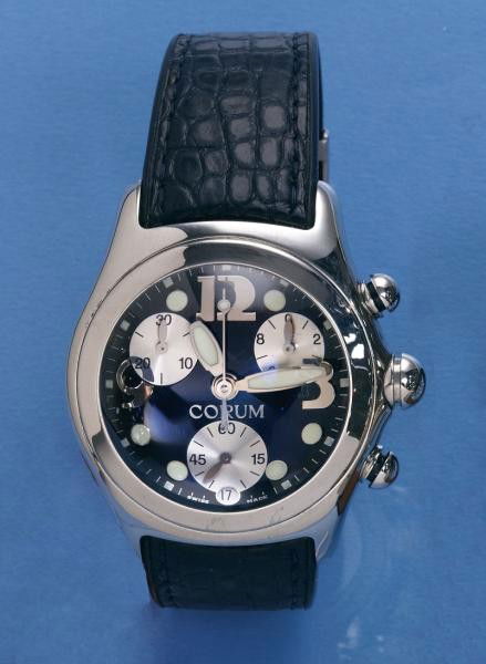 CORUM WATCH: Man's stainless steel Corum chronograph (bubble) watch. Watch has large blue dial, quartz movement and leather strap.