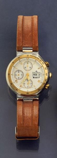 BAUME & MERCIER WATCH: Stainless steel chronograph with day-date and brown leather strap with stainless buckle attachment.