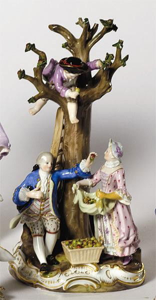 MEISSEN GROUP OF APPLE PICKERS: Depicting a couple and two children, one on a three, broken branches, crossed swords mark, 19th/20th century. Height 10 in.