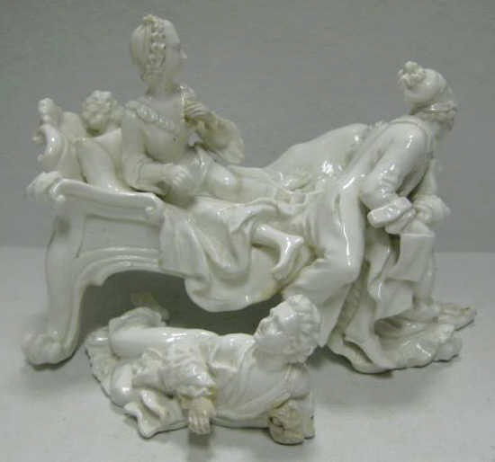 MEISSEN GROUP 'LOVER DISCOVERED': Molded in Blanc-de-Chine after Kaendler design as two separated pieces of a couple seated on a bed with cupid behind pillow and a wife's lover, missing dog figure and a tea table, imperfections. Group