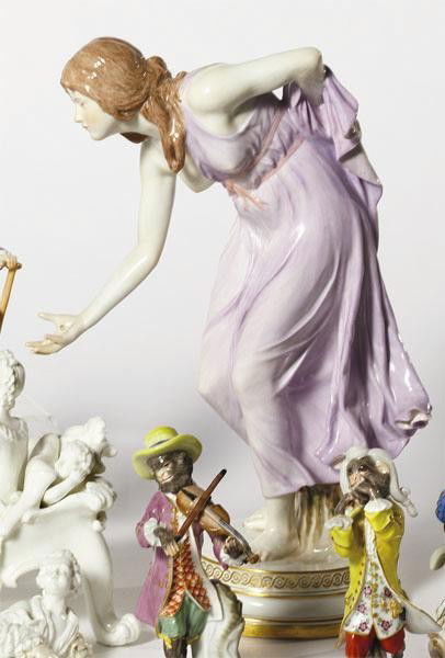 MEISSEN PORCELAIN FIGURE, 'GIRL PLAYING BALL': Jugendstil style, molded after Walter Schott design, a young woman wearing lilac dress with gilt bowl in her right hand, crossed swords blue underglaze mark with one incision, early 20th century. Heig