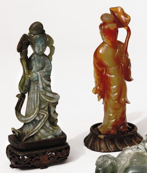 TWO CHINESE CARVED MINERAL BEAUTIES: Each holding flowering branch, carnelian and green with flowing robes. Heights: 5 7/8 in; 5 1/2 in.
