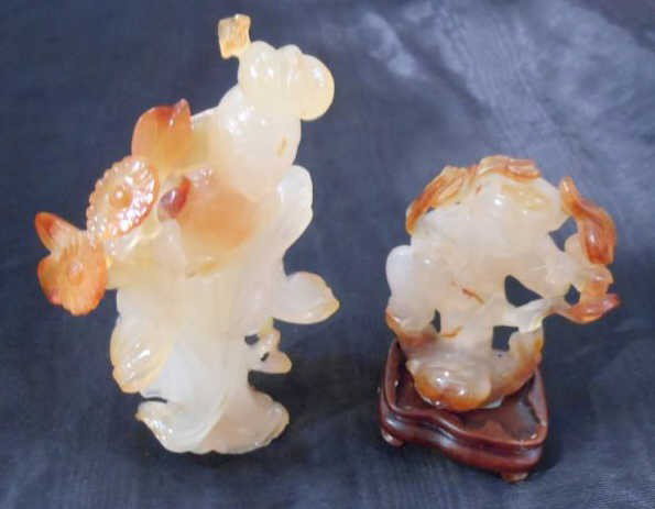 TWO CHINESE SCULPTED CARNELIAN FIGURES: A Beauty holding flowering branch and a man with dragon. Heights: 5 in; 3 in.