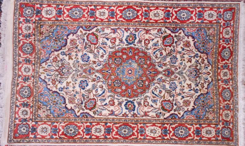 PERSIAN THROW RUG: Blue on deep red foliate pole medallion, on the floral filled ivory field with sky blue spandrels, ivory and red border. 3 ft. 3 in. x 5 ft.