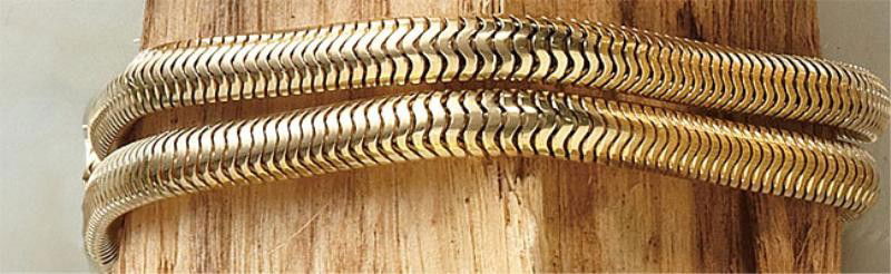 SERPENTINE CHAIN BRACELETS, PAIR: Two 14k yellow gold chain bracelets. Three links on one bracelet are soldered together. 7 1/2 inches. 35.6 grams.