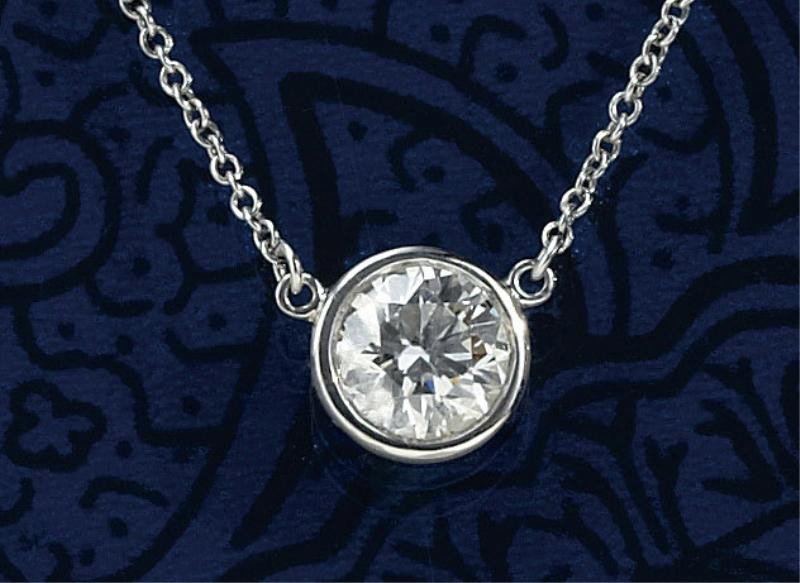 DIAMOND PENDANT, TIFFANY & CO. PERETTI: Platinum necklace with one bezel set round brilliant cut diamond weighing .77ct. Necklace is accompanied by a Tiffany & Co appraisal stating Color I, Clarity VVS2.