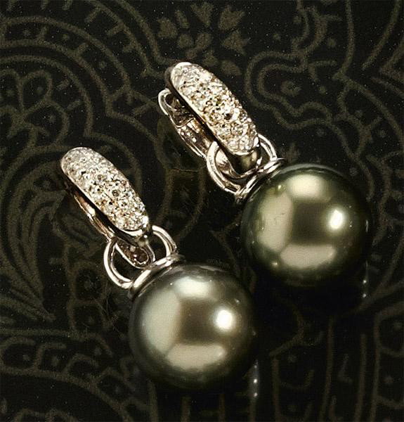 TAHITIAN PEARL AND DIAMOND EARRINGS: 18k white gold huggies set with thirty-eight round brilliant cut diamonds weighing 18ct.t.w. Earrings suspend two dangling 11mm dark grey Tahitian pearls.