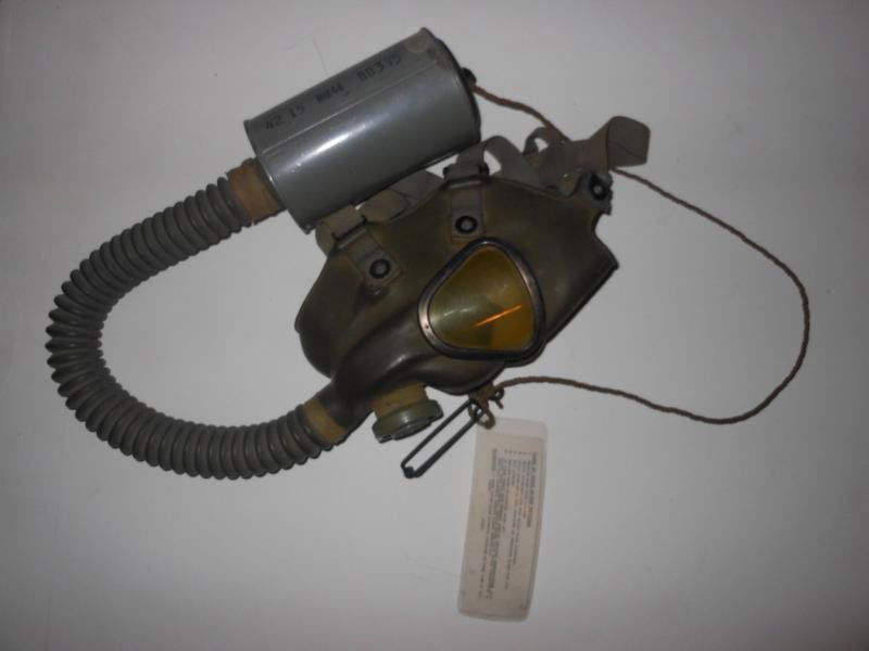 U.S. WWII LIGHTWEIGHT GAS MASK: Goodyear, 1942 date, mask, hose and filter canister (lacking bag) with hanging care tag.