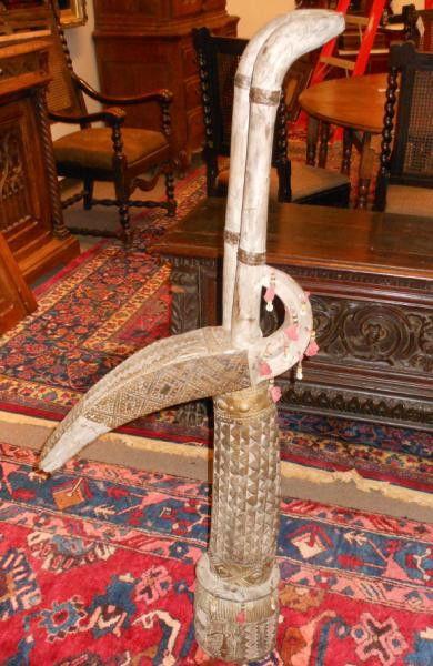 KURUMBA ADONE ANTELOPE HEADDRESS: Burkino Faso, carved wood decorated with copper sheet, beads and cowry shells, loss of one ear. 48 3/4 Inches